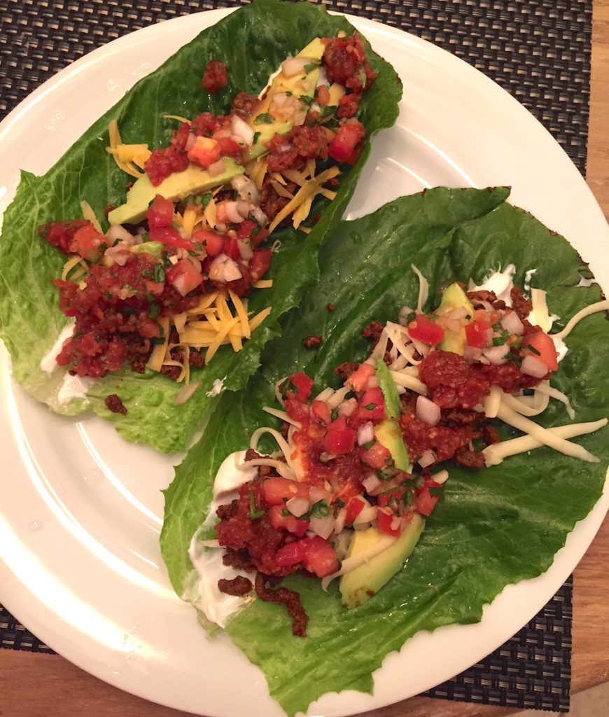 Beef tacos on lettuce with pico de gallo and roasted chipotle salsa