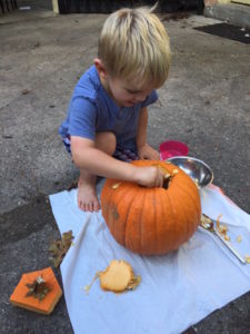 Carving pumpkins outside