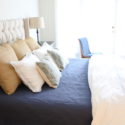 Simple additions to a white bed give it a more sophisticated and welcoming look