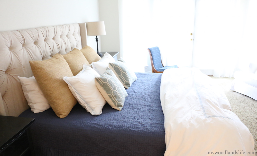 Simple additions to a white bed give it a more sophisticated and welcoming look 