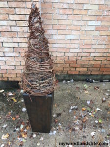 Adding vines to chicken wire cone for DIY grapevine Christmas Trees