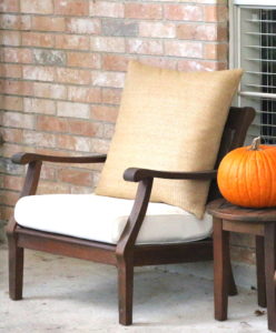 Adding an oversized natural fiber pillow to outdoor furniture for added comfort