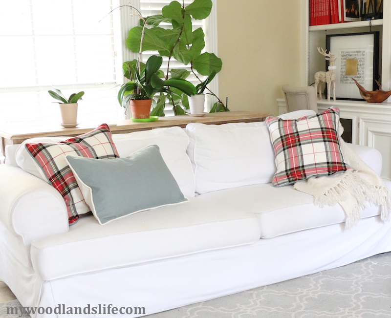 DIY piped plaid pillows on white couch for holidays