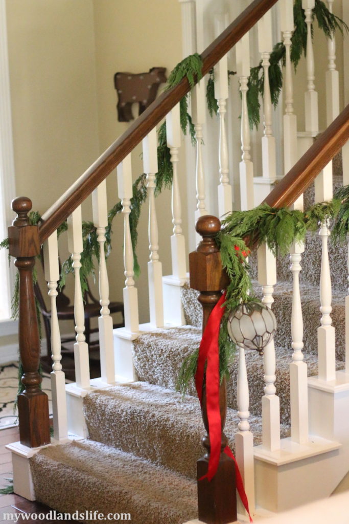 Mywoodlandslife christmas home tour live cedar garland on stairs