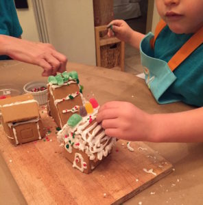 Making wilton mini gingerbread house village with toddler