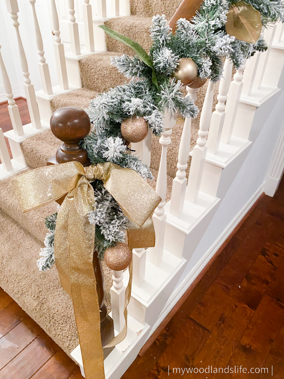 Adding real magnolia leaves ribbon and ornaments to inexpensive Walmart flocked garland