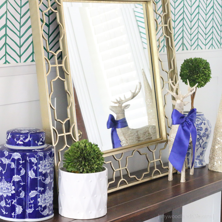 Blue and white chinoiserie Christmas entryway with topiaries and ginger jars 