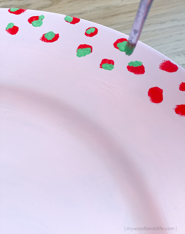 How to make a DIY handpainted pink, green and red Christmas-themed charger plate using a $2 plastic charger