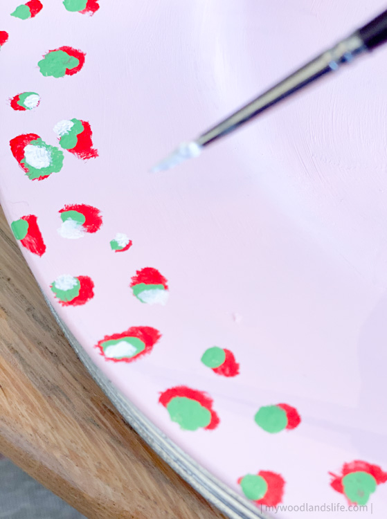 How to make a DIY handpainted pink, green and red Christmas-themed charger plate using a $2 plastic charger
