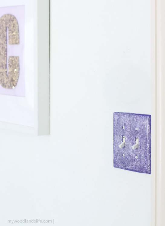 DIY purple glitter switch plate cover installed on wall