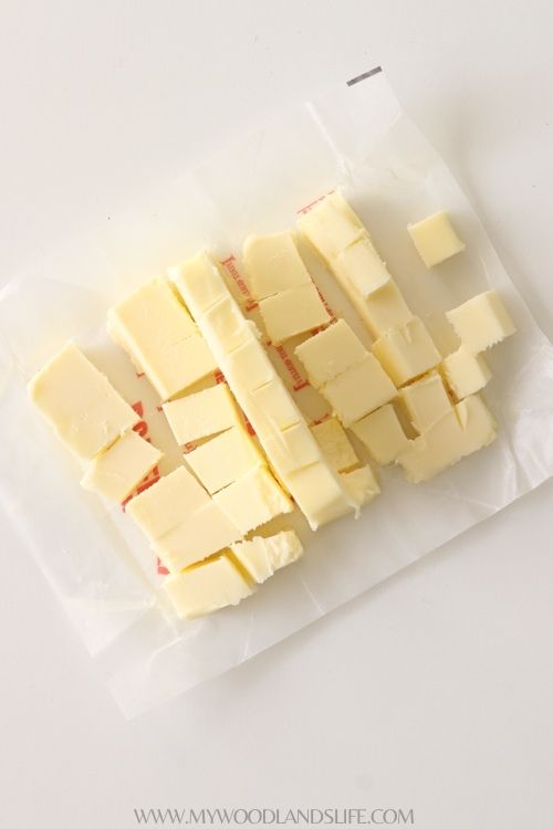 Stick of butter cut into small pieces on top of wrapper