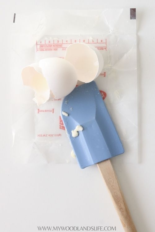 Egg shells and rubber spatula on butter wrapper