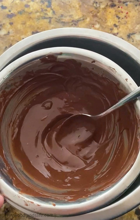 Making chocolate coating for Valentine's Day themed cake pops using chocolate chips and shortening and boiling water in metal bowls