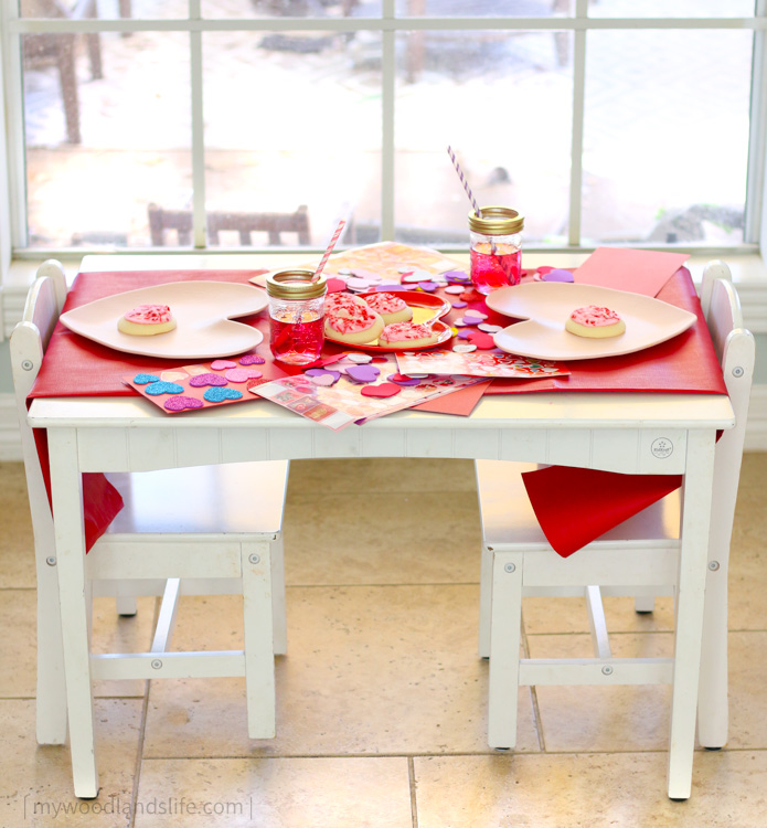 Kids Valentines Day table decoration for card decorating party with heart plates and stickers and red table runner