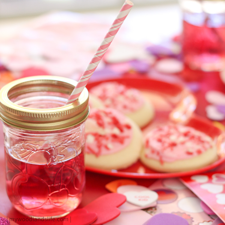 Valentines party decor for kid table mason jar with red juice sugar cookies