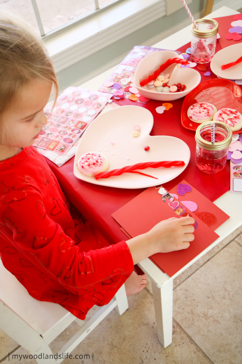 Decorating Valentines cards during our party on a Valentines themed kid table