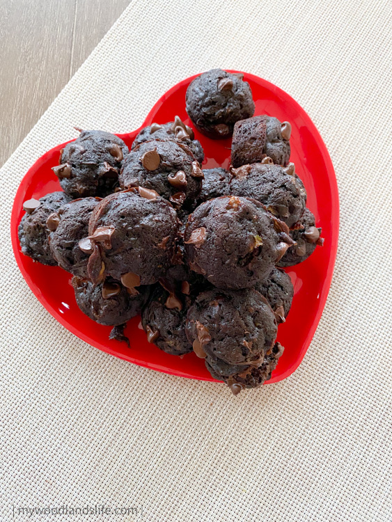 Chocolate zucchini mini muffins on red heart plate for Valentine's Day
