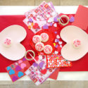 Kids Valentines Day table decoration for card decorating party with heart plates and stickers and red table runner