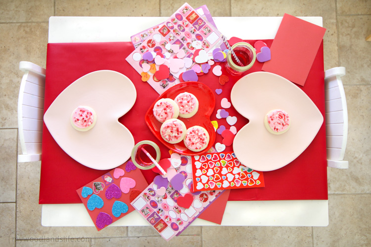 Kids table Valentines Day table decoration for card decorating party with heart plates and stickers and red table runner