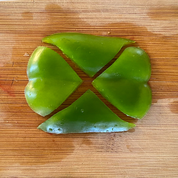 Side of green bell pepper cut into two heart shapes