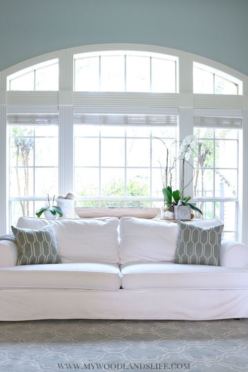 Coastal family room white couch with gray blue walls