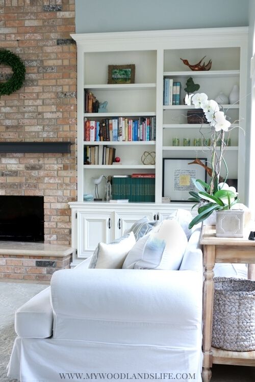 Coastal family room white couch with gray blue walls